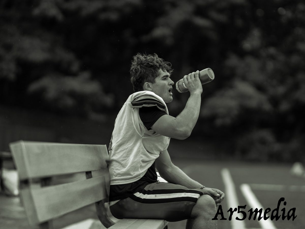 Junior Thomas Diemar sipping water during the annual red white scrimmage 