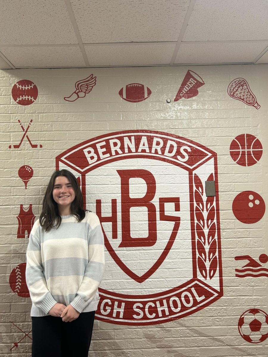 Claire poses in front of a BHS sports mural. 