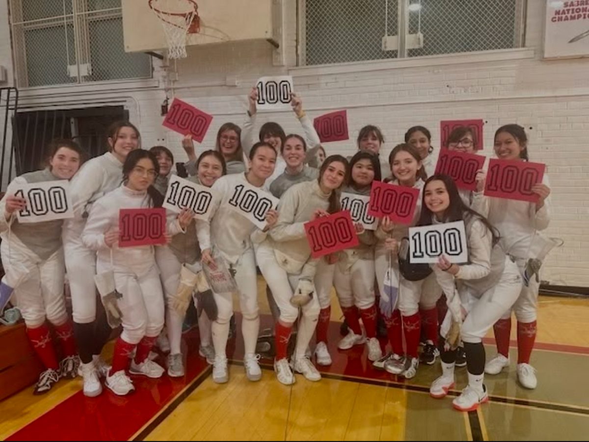 Girls fencing team celebrating Stella
Macdonald-Salerno’s 100th career win