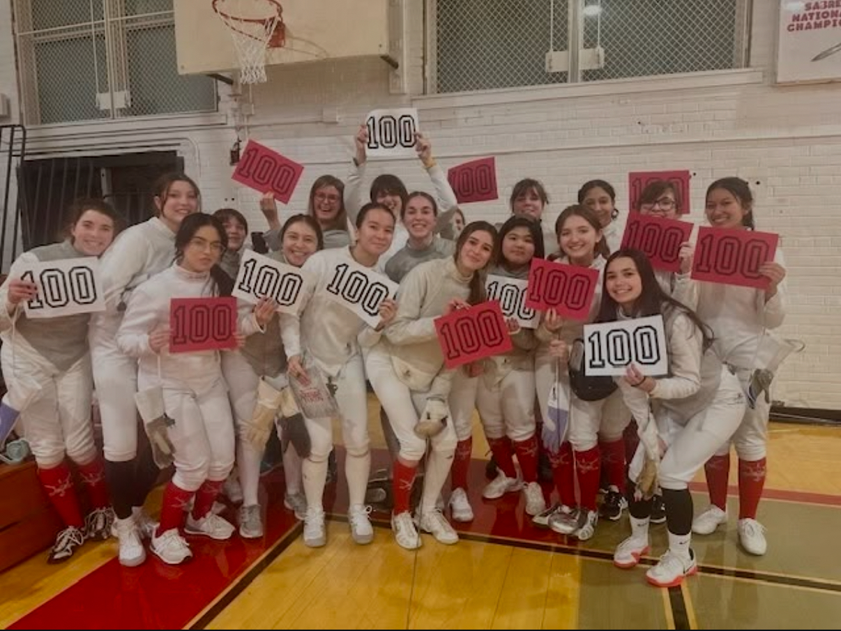 Girls fencing team celebrating Stella
Macdonald-Salerno’s 100th career win